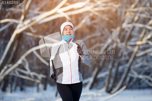 Image of Sport woman in winter forest