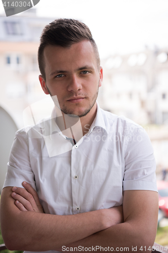 Image of man standing at balcony