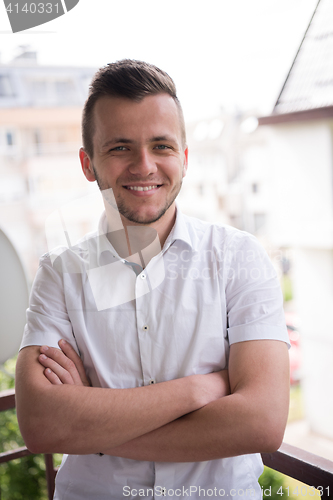 Image of man standing at balcony