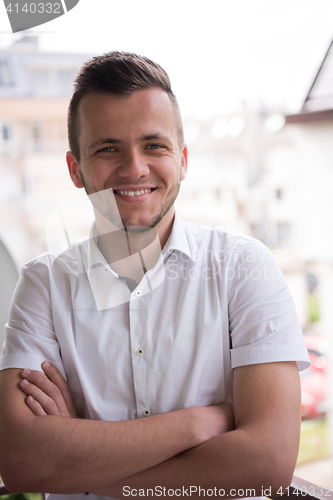 Image of man standing at balcony