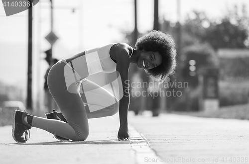 Image of Portrait of sporty young african american woman stretching outdo