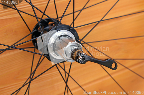 Image of bike rear wheel against brown background.