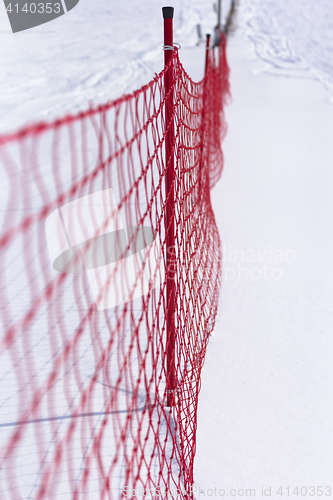 Image of Plastic fence and snow.