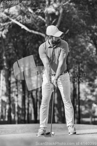 Image of golf player hitting shot with club