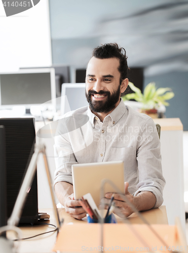 Image of happy creative male office worker with tablet pc