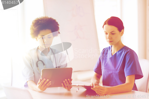 Image of doctors with tablet pc meeting at hospital