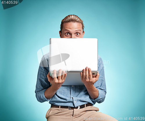 Image of Sad Young Man Working On Laptop