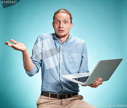 Image of Sad Young Man Working On Laptop