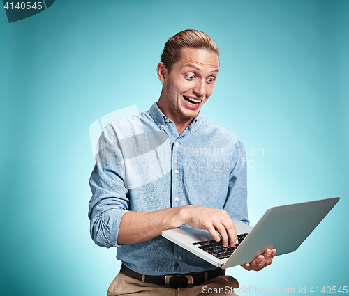 Image of Sad Young Man Working On Laptop