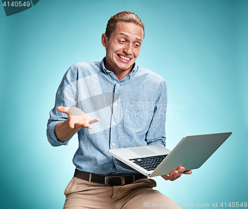 Image of Sad Young Man Working On Laptop