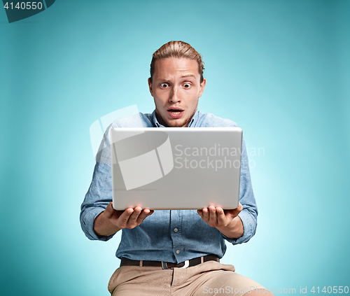 Image of Sad Young Man Working On Laptop