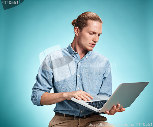 Image of Sad Young Man Working On Laptop