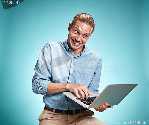 Image of Sad Young Man Working On Laptop