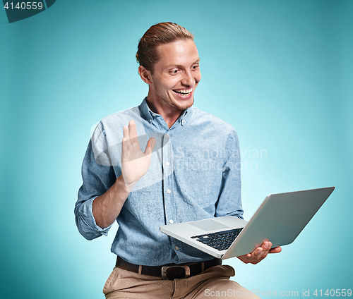 Image of Sad Young Man Working On Laptop