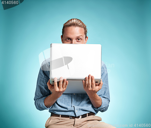 Image of Sad Young Man Working On Laptop