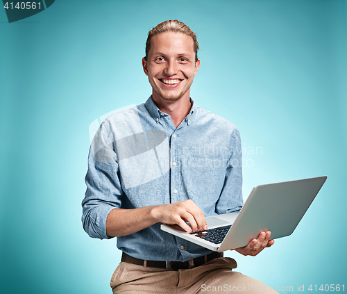 Image of Sad Young Man Working On Laptop