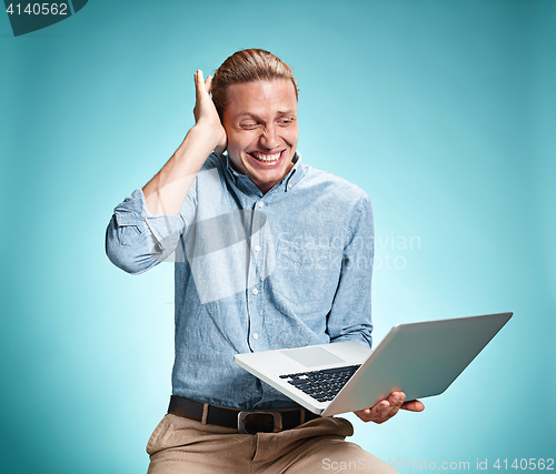 Image of Sad Young Man Working On Laptop
