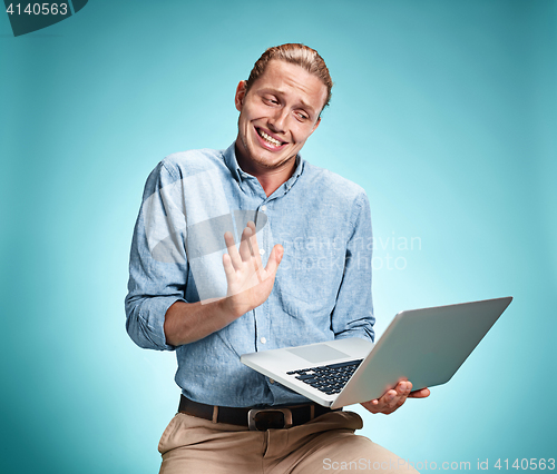 Image of Sad Young Man Working On Laptop