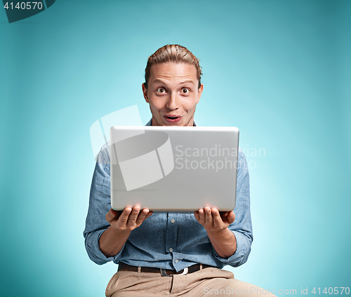 Image of Sad Young Man Working On Laptop