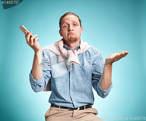 Image of The young surprised caucasian man on blue background