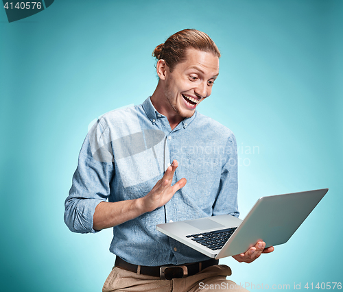 Image of Sad Young Man Working On Laptop