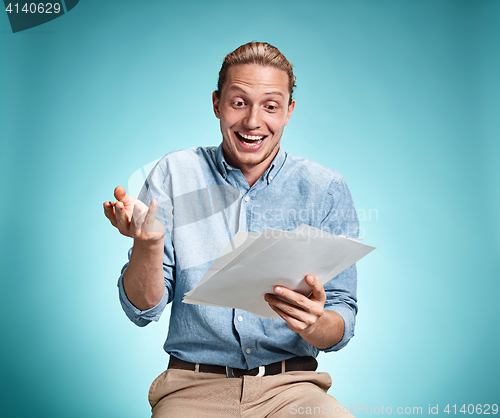 Image of Smart smiling student with great idea holding notebook