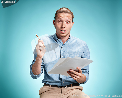 Image of Smart surprised student with great idea holding sheets of paper