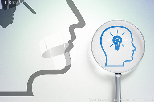 Image of Information concept:  Head With Lightbulb with optical glass on digital background