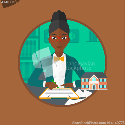 Image of Real estate agent signing contract.