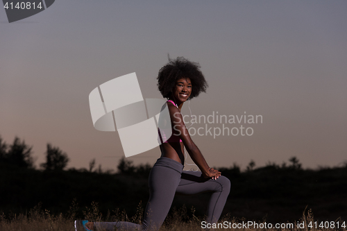 Image of black woman is doing stretching exercise relaxing and warm up