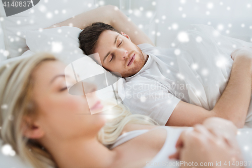 Image of happy couple sleeping in bed at home