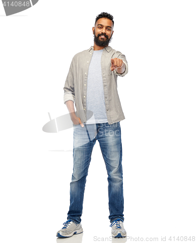 Image of happy smiling indian man pointing finger to you