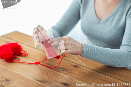 Image of woman hands knitting with needles and yarn