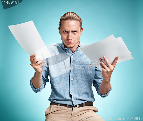 Image of Smart smiling student with great idea holding sheets of paper