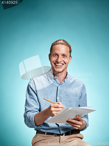 Image of Smart smiling student with great idea holding notebook