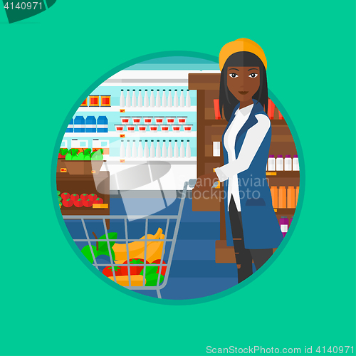 Image of Customer with shopping trolley at supermarket.