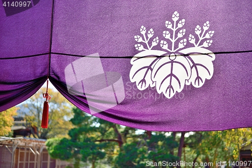Image of Purple Japanese temple curtain with historical emblem of Toyotomi clan.