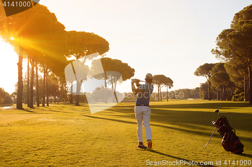 Image of golf player hitting shot with club