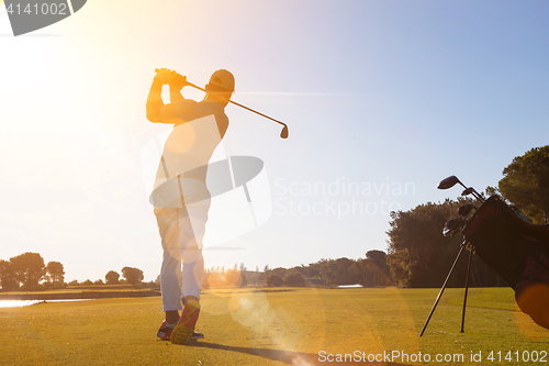 Image of golf player hitting shot with club