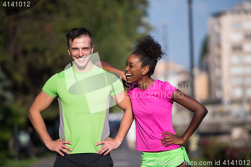 Image of portrait of young multietnic jogging couple ready to run