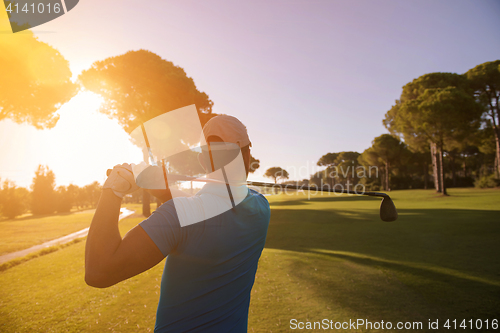 Image of golf player hitting shot with club