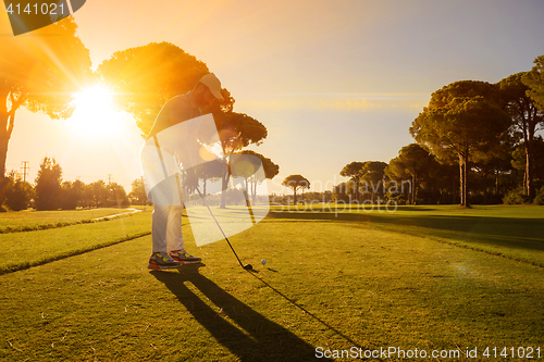 Image of golf player hitting shot with club