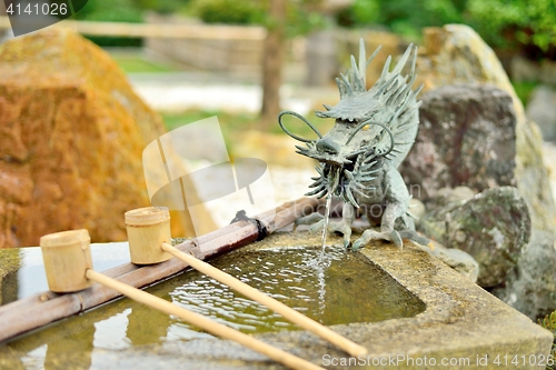 Image of Japanese washbasin, tsukubai, with a dragon fountain