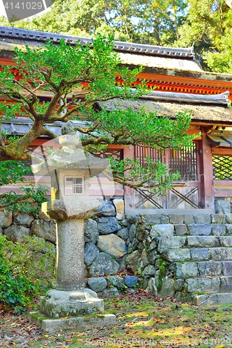 Image of Japanese stone lantern and temple gates.