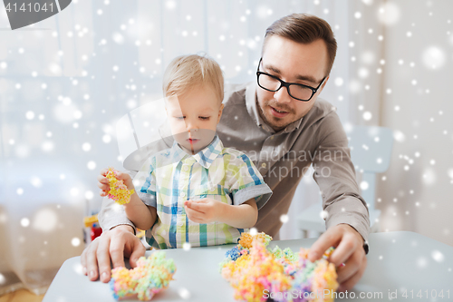 Image of father and son playing with ball clay at home