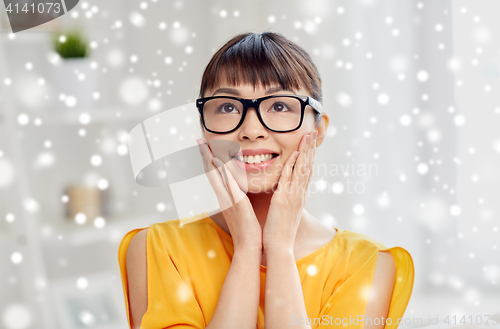 Image of happy asian young woman in glasses at home