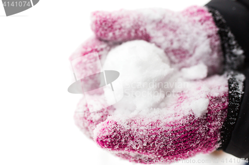 Image of close up of woman holding snowball outdoors