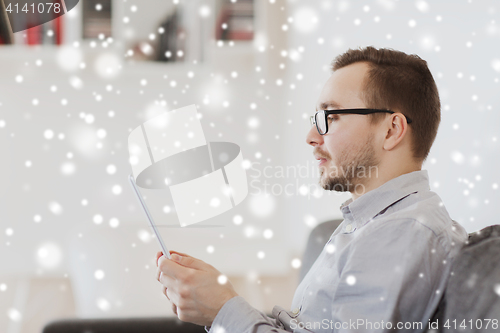 Image of man with tablet pc at home over snow