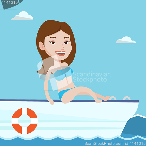 Image of Young happy woman tanning on sailboat.