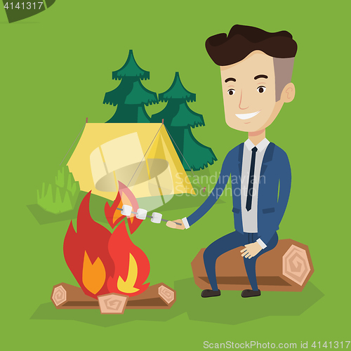 Image of Businessman roasting marshmallow over campfire.